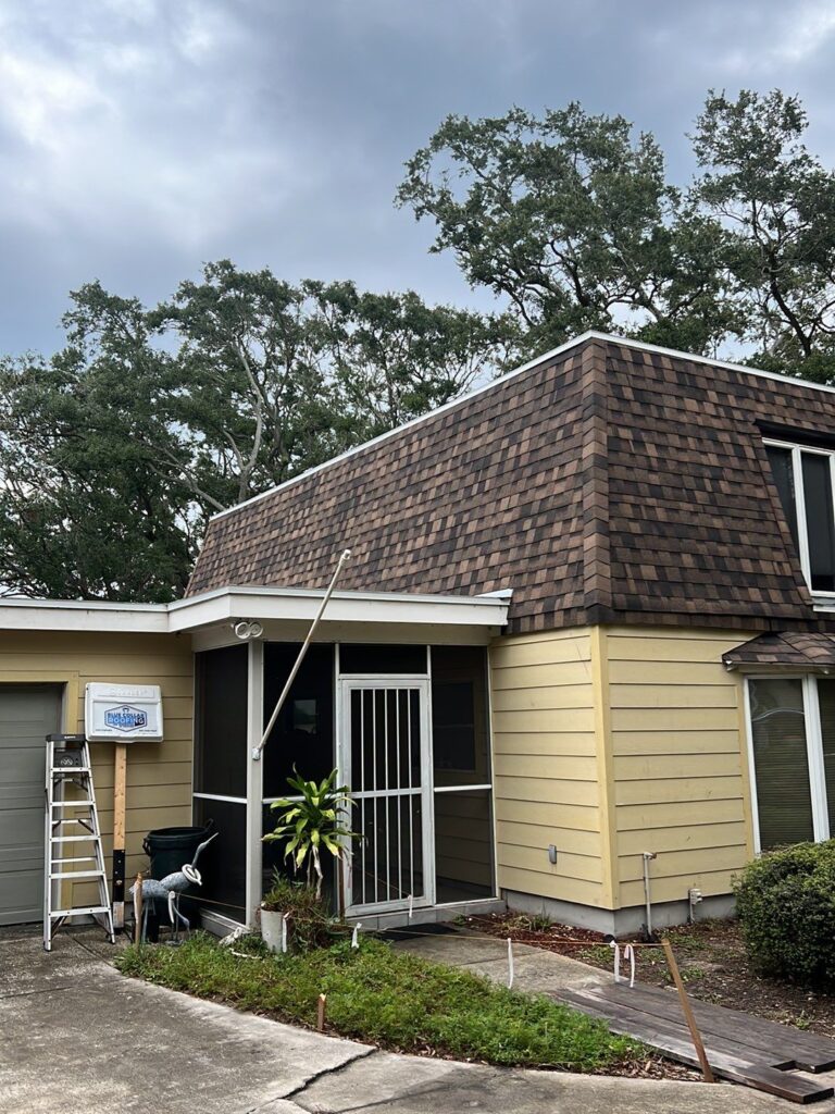 House with brown roof and yellow wall - Roof Repair Services Sarasota, FL
